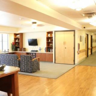 A modern lobby with comfortable seating and a television.