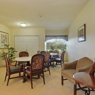 A cozy dining area with a table, multiple chairs, and decorative elements.
