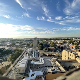 A panoramic view of the city showcasing modern architecture under a clear blue sky.