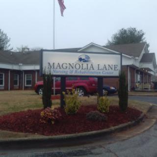 Entrance of Magnolia Lake, featuring a welcoming sign and landscaped surroundings.
