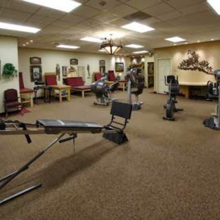 A well-equipped gym featuring various exercise machines in a comfortable setting.