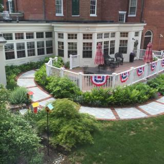 A beautifully landscaped patio area with festive decorations and lush greenery.