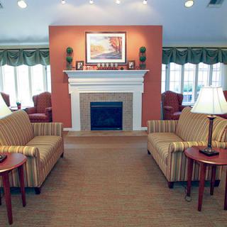 A cozy living room featuring a fireplace, two sofas, and elegant decor.