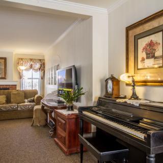 Cozy living room with a piano and traditional decor.