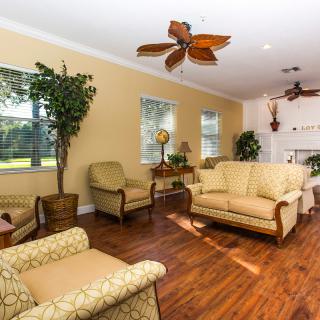 A cozy living room with comfortable seating, decorative plants, and abundant natural light.