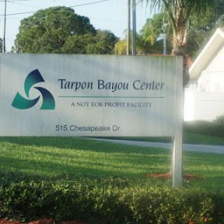 Signage for the Turpon Bayou Center, a notable facility located in a scenic outdoor setting.