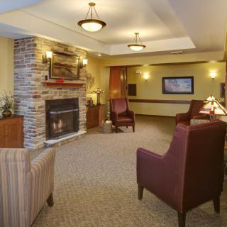 A cozy living room with a fireplace and comfortable seating.