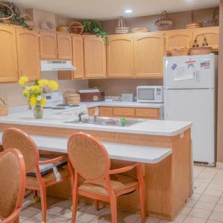 A cozy kitchen with wooden cabinets, a central island, and modern appliances.
