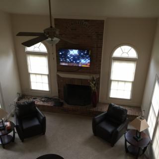 A cozy living room with a fireplace and TV, viewed from above.