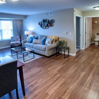 A modern living room with hardwood floors and stylish furnishings.