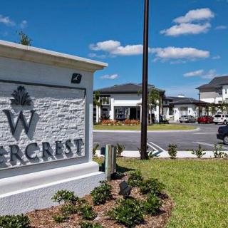 Entrance sign for a residential complex on a sunny day with clear skies.