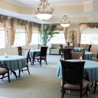 An elegant dining room with decorated tables and chandeliers.