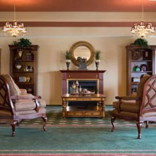A vintage-inspired living room with elegant furniture and a cozy fireplace.