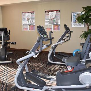 A fitness room with several stationary bikes and exercise equipment.