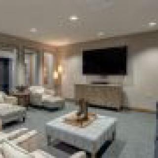 A modern living room with comfortable seating and a large television.