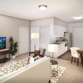 A modern apartment with an open floor plan combining the living room and kitchen area, featuring contemporary furniture.