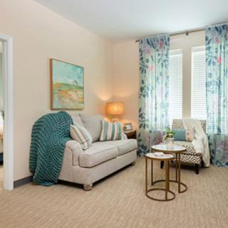 Cozy living room with a sofa, armchair, and decorative elements.