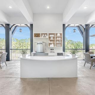 A beautifully designed modern kitchen with a sleek countertop and stunning views of the outdoors.