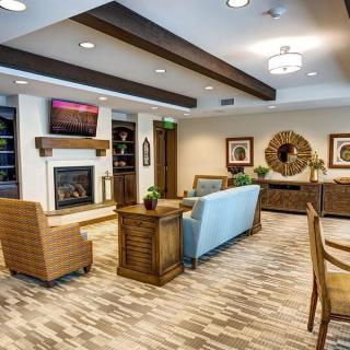 A modern living room with cozy seating, a fireplace, and stylish decor.