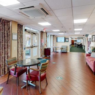 A welcoming lounge space featuring comfortable seating and dining areas, ideal for social interaction and relaxation.