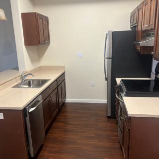 A modern kitchen with wooden cabinets and stainless steel appliances.