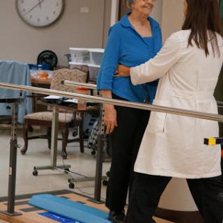 A physical therapist assisting a patient during a rehabilitation session.
