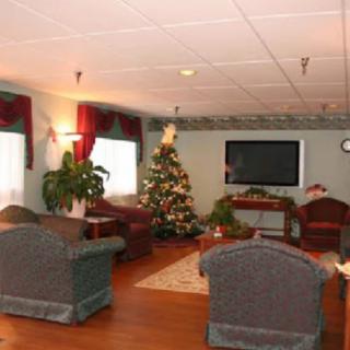 Cozy living room with holiday decorations and a Christmas tree.