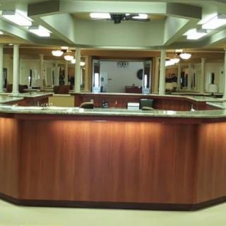 A spacious office reception area featuring a large wooden counter.