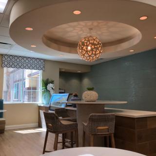 A modern and stylish seating area with elegant lighting and natural light filtering through the windows.