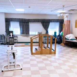 A rehabilitation room equipped with exercise machines and facilities for physical therapy.
