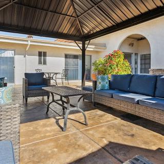 A cozy outdoor patio with comfortable seating under a gazebo, perfect for relaxation.