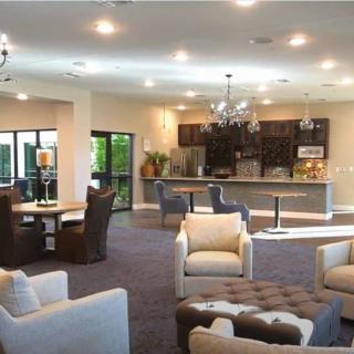 A modern open-concept living room with a kitchen and comfortable seating.