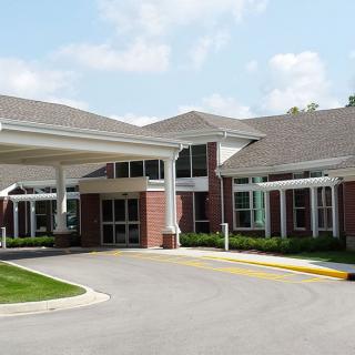 Front view of a hospital entrance with a driveway.