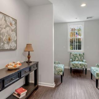 A cozy living room with chairs, a table, and decorative elements.