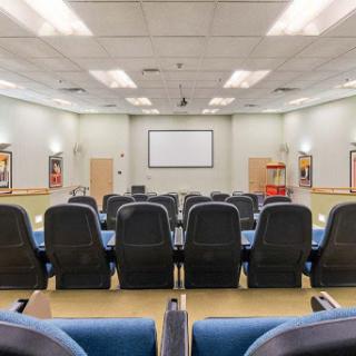 A spacious auditorium equipped with comfortable seating, designed for presentations and meetings.