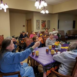 A group of elderly people participating in a social gathering indoors.