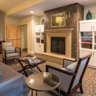 A modern living room with a fireplace and stylish furniture.