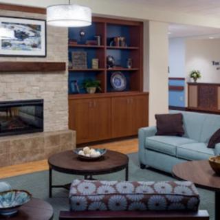 A modern living room with a cozy fireplace and stylish furniture.