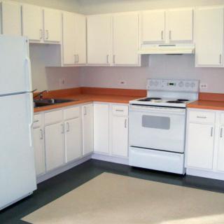 A clean, modern kitchen with white cabinets and appliances.