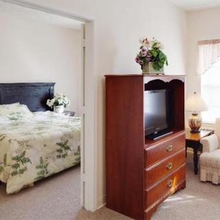 A cozy apartment interior with a view of the bedroom and living area.