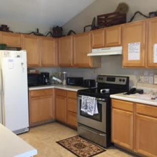 A cozy kitchen with wooden cabinets and modern appliances.