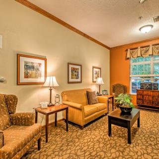 A cozy living room with comfortable seating and warm lighting.