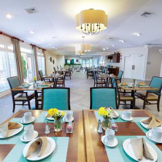 A well-arranged dining room with neatly set tables and elegant decor.