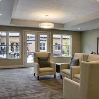 A modern living room with comfortable seating and large windows.