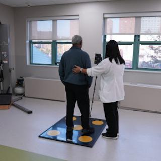 A patient undergoing rehabilitation with the assistance of a therapist in a clinical setting.