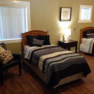 A cozy bedroom with two twin beds and elegant decor.