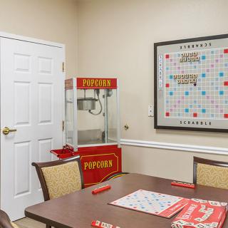A cozy game room featuring a popcorn machine and a Scrabble board.