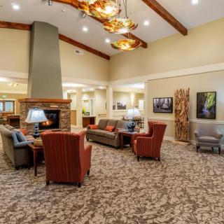 A spacious lounge area featuring comfortable seating and a fireplace.