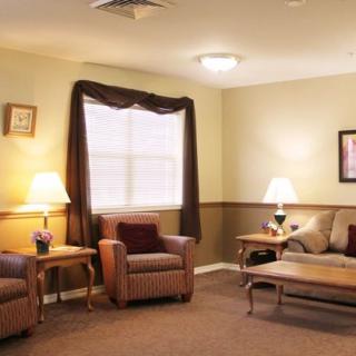 A cozy living room with comfortable seating and warm lighting.