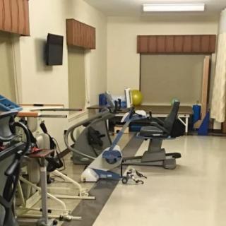 A small indoor gym with various exercise equipment including treadmills.